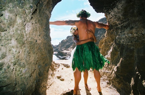 Jamillah and Brandon in a lava tube cave by the beach, in the afternoon light