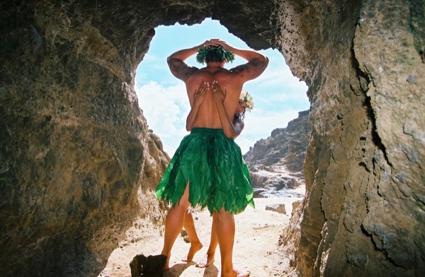 Jamillah and Brandon in a lava tube cave by the beach, having fun