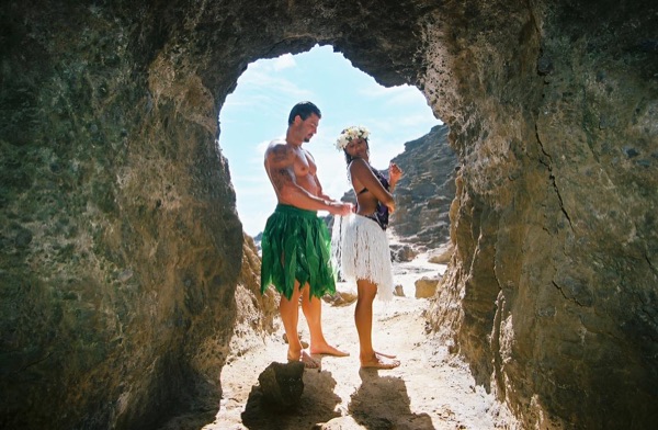 Jamillah and Brandon in a lava tube cave by the beach, in the sunshine