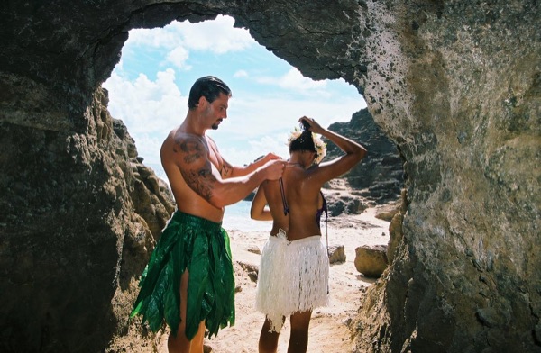 Jamillah and Brandon in a lava tube cave by the beach, side by side