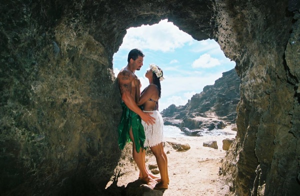 Jamillah and Brandon in a lava tube cave by the beach, in a happy moment