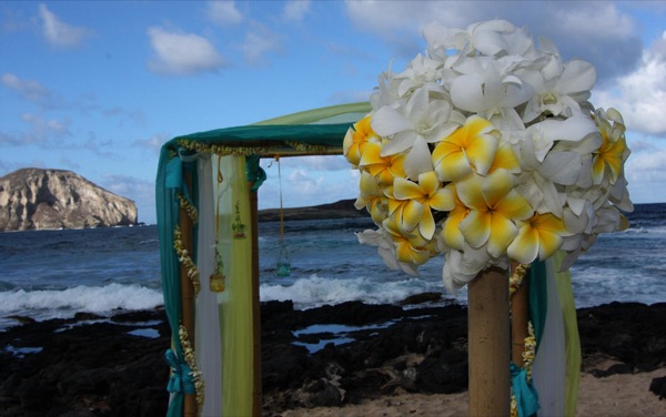 A yellow bouquet hanging on the gazebo