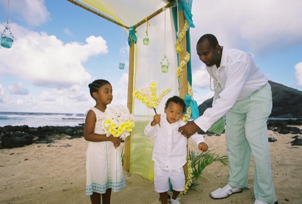 Kids playing with the yellow flower bouquets by the gazebo, close up