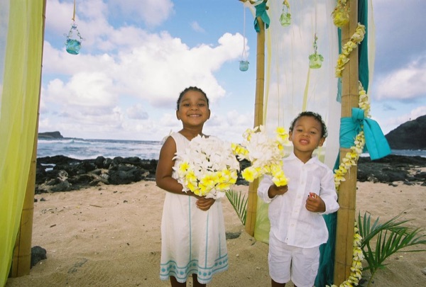 Kids playing with the yellow flower bouquets by the gazebo, from another angle