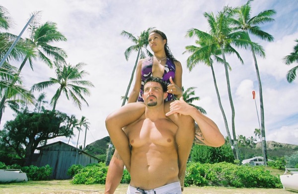 Jamillah and Brandon on the white sand at Lanikai, in a happy moment