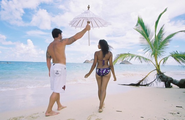 Jamillah and Brandon on the white sand at Lanikai, wide view