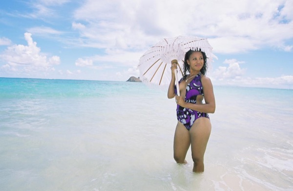 Jamillah and Brandon on the white sand at Lanikai, in the afternoon light