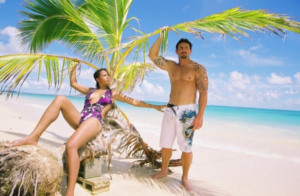 Jamillah and Brandon on the white sand at Lanikai, smiling