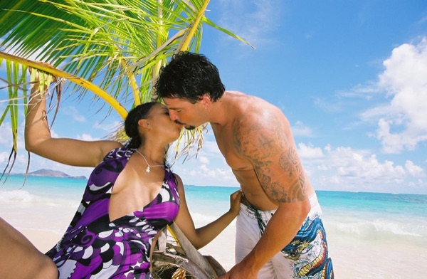Jamillah and Brandon on the white sand at Lanikai, in the sunshine