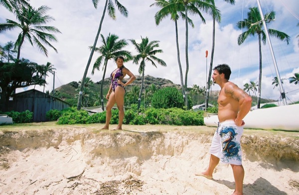 Jamillah and Brandon on the white sand at Lanikai, laughing together
