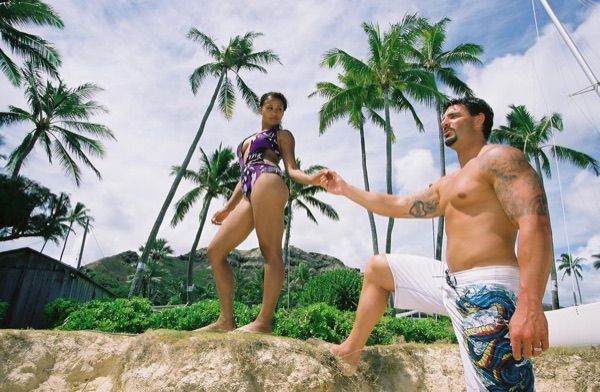 Jamillah and Brandon on the white sand at Lanikai, under a blue sky