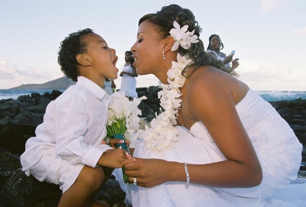 Jamillah and Brandon kissing by the sea