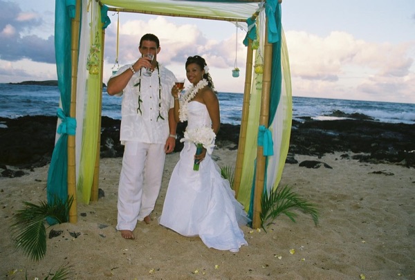 The newlyweds smiling under the gazebo