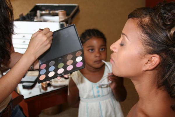 The flower girl getting her makeup done