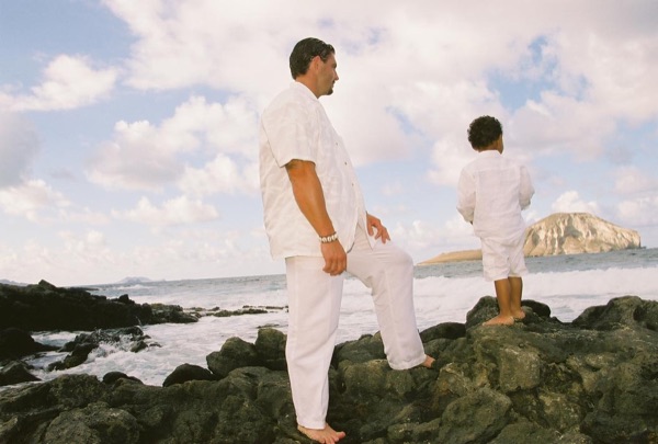 Brandon playing with his son Cameron on the beach, close up