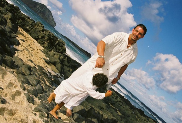 Brandon playing with his son Cameron on the beach, laughing together