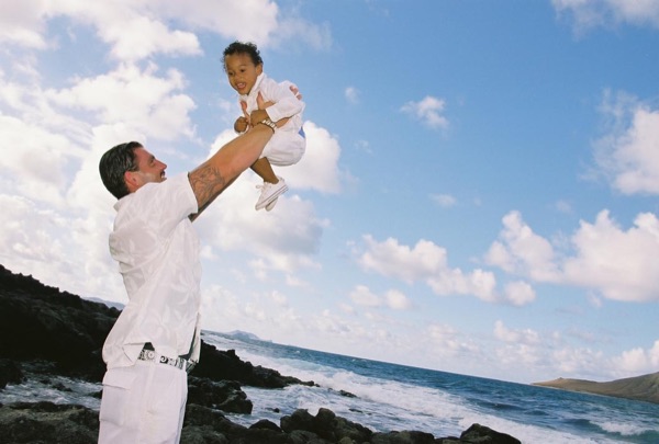 Brandon playing with his son Cameron on the beach