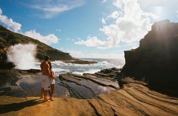 Jamillah and Brandon on the east coast cliffs above the Pacific, in a playful moment