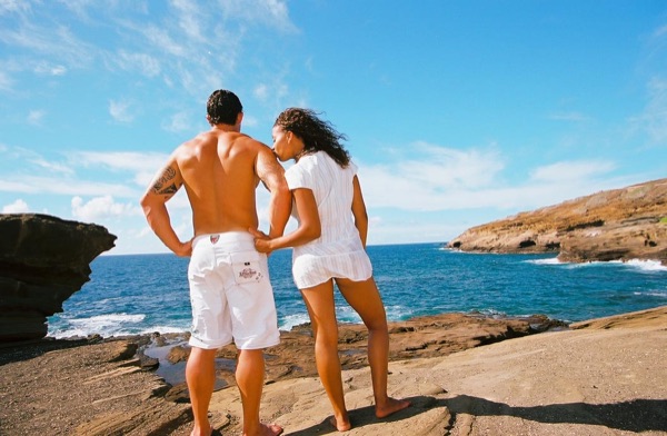 Jamillah and Brandon on the east coast cliffs above the Pacific, hand in hand