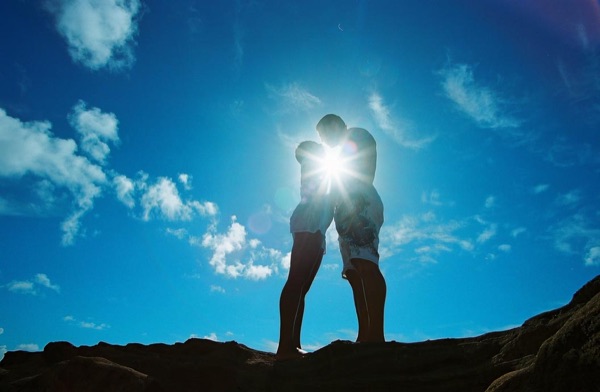 Jamillah and Brandon on the east coast cliffs above the Pacific, with the clouds above
