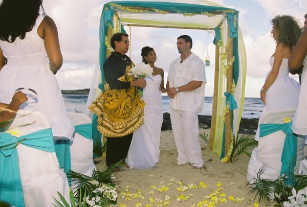 Jamillah and Brandon with the Hawaiian minister at their ceremony, smiling
