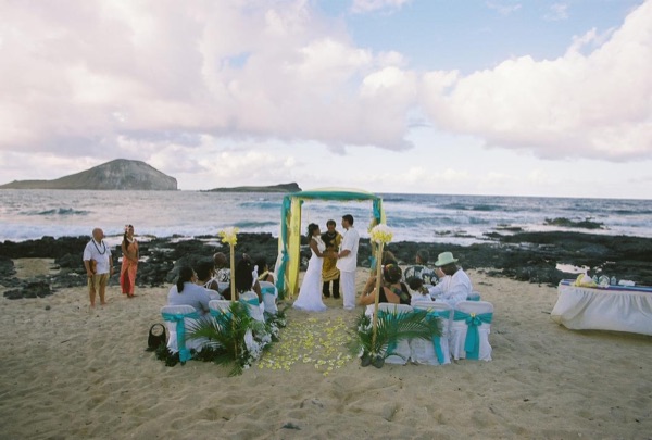 Jamillah and Brandon's turquoise themed beach ceremony, under a blue sky