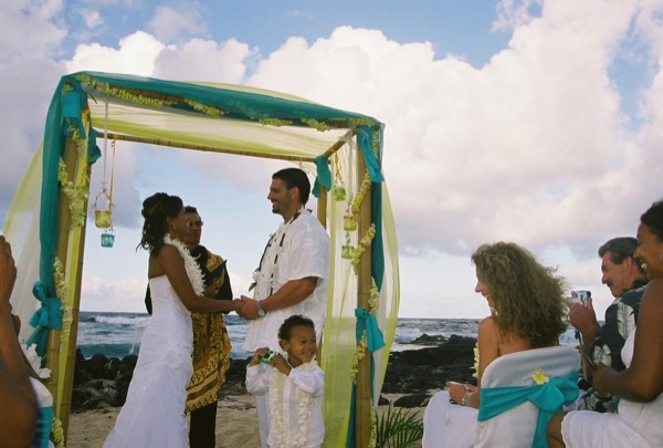 Jamillah and Brandon's turquoise themed beach ceremony, looking at each other