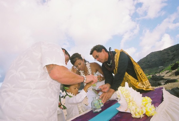 Jamillah and Brandon's turquoise themed beach ceremony, in a playful moment