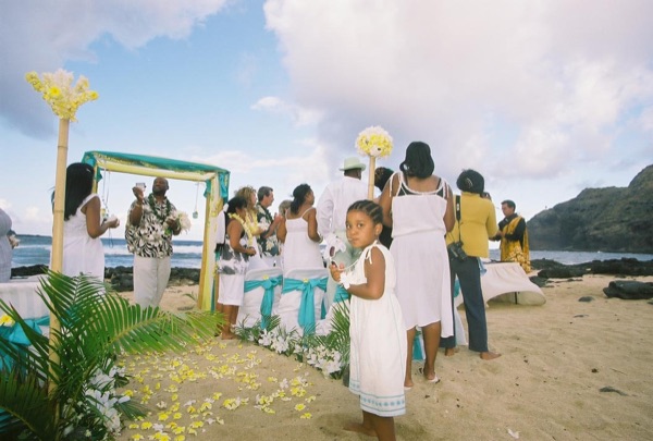 Jamillah and Brandon's turquoise themed beach ceremony, arm in arm