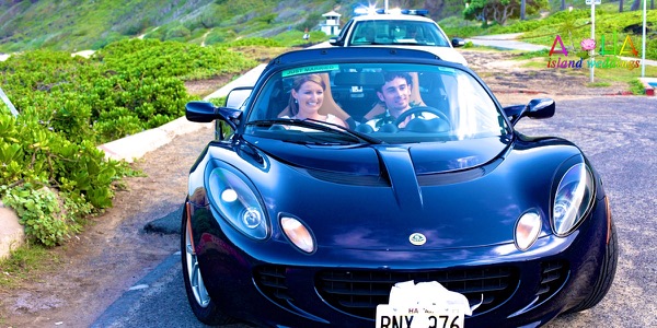 Jennifer and David with the blue Lotus sports car by the sea, another moment