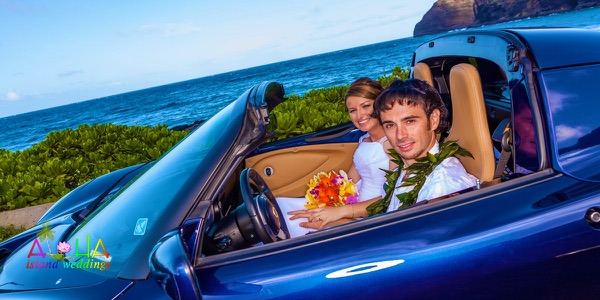 Jennifer and David with the blue Lotus sports car by the sea, another photo