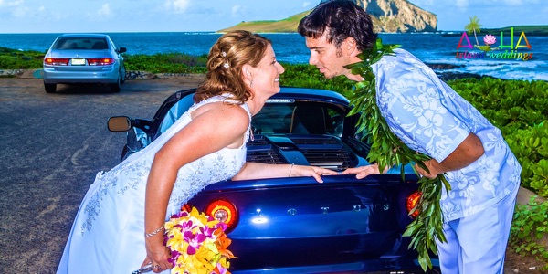 Jennifer and David with the blue Lotus sports car by the sea, photo 2