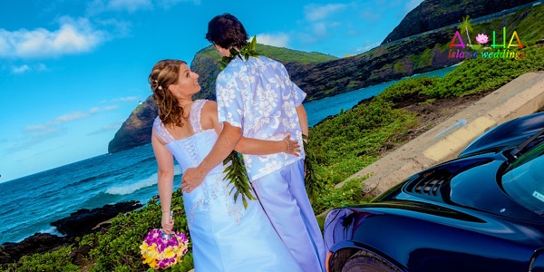 Jennifer and David with the blue Lotus sports car by the sea, photo 3