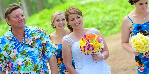 The groomsmen in bright aloha shirts on the beach, a different view