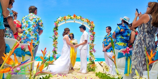 Jennifer and David under the tropical flower arch