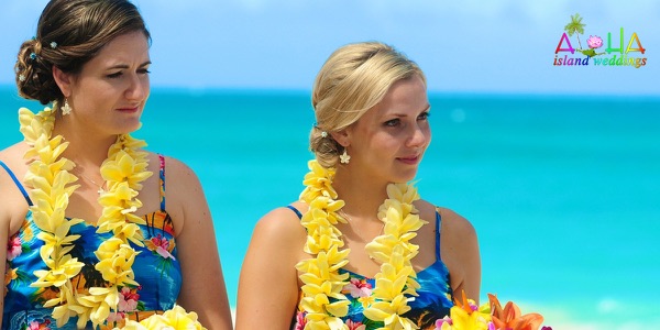 Guests watching the ceremony by the turquoise water, another view