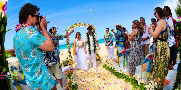 Guests watching the ceremony by the turquoise water, one more moment
