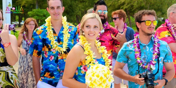 The groomsmen in bright aloha shirts on the beach, another photo