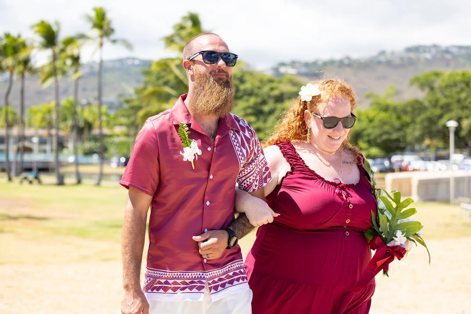 The bridal party walking across the park to the beach