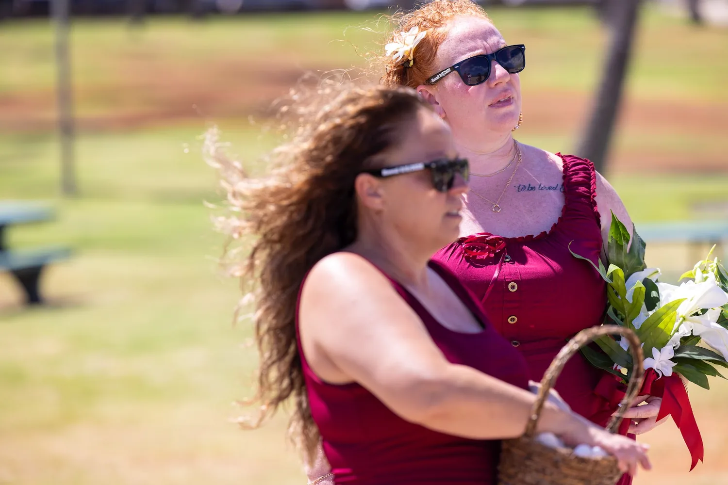 A bridesmaid in wine red with her bouquet