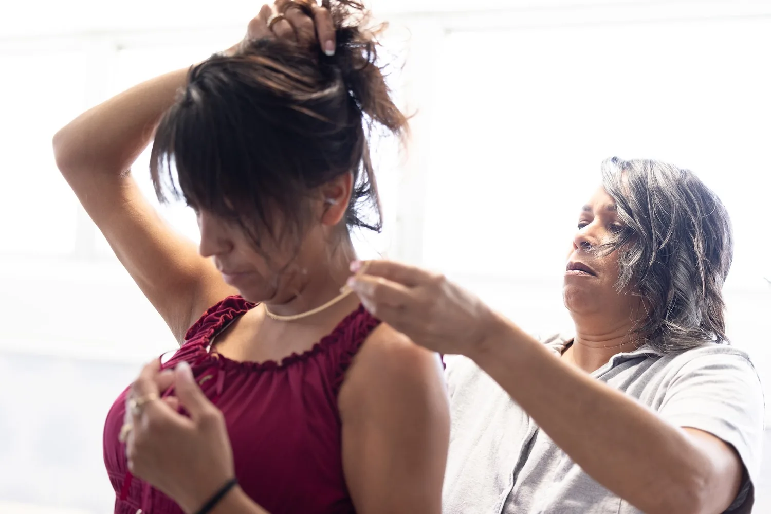 Bridesmaids helping each other get ready