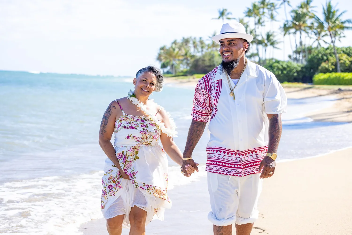 Jocelyn and Erick holding hands on the beach