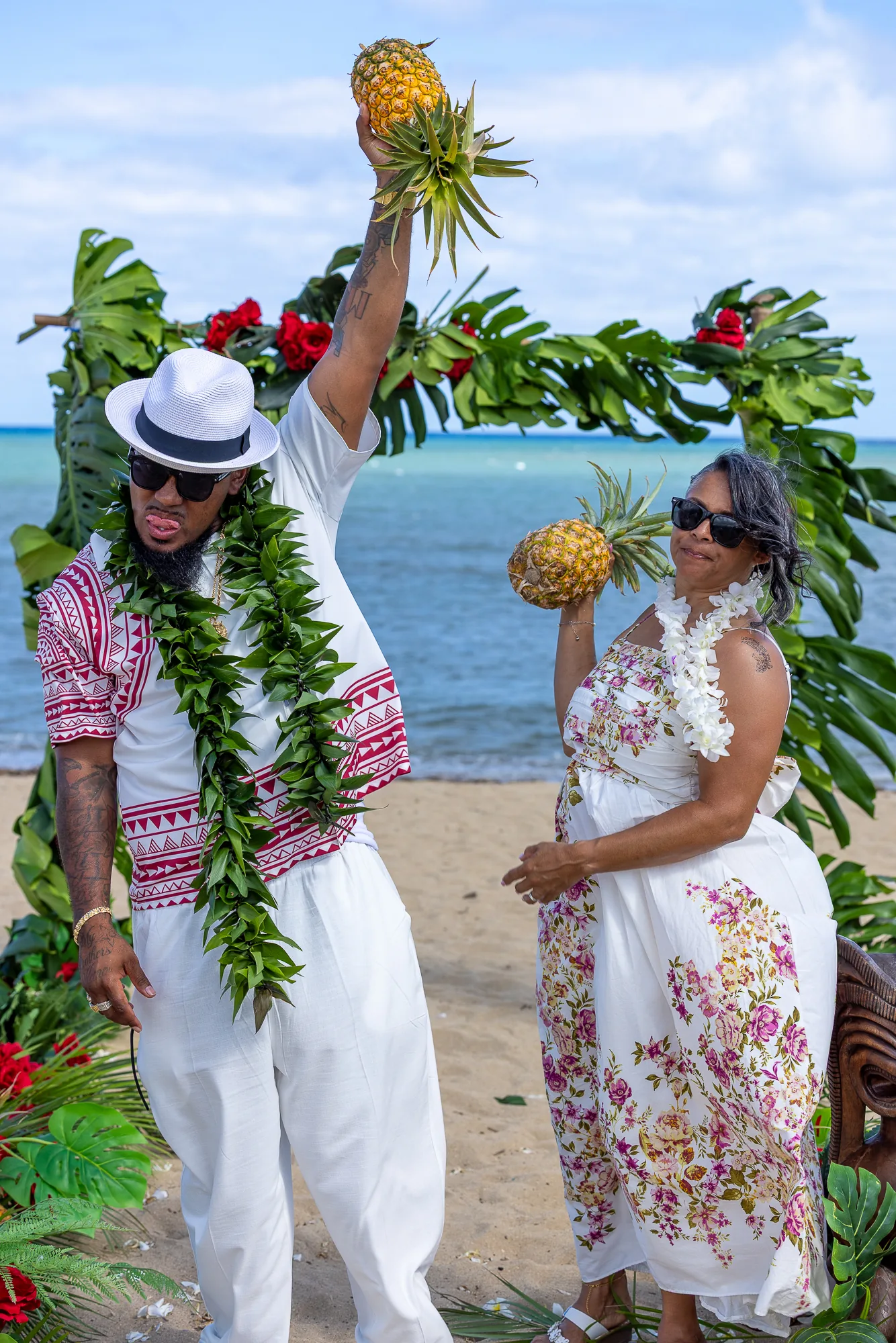 Erick holding a pineapple high