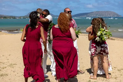 The bridal party celebrating on the beach