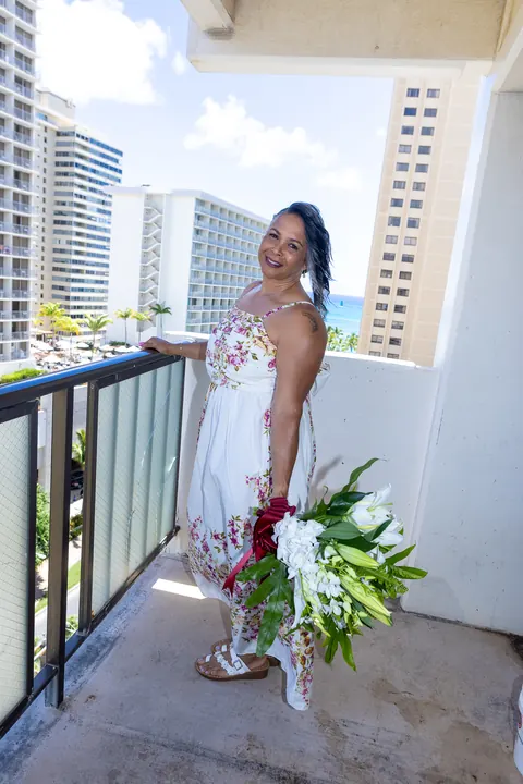 Bridal portrait on the balcony with the city behind