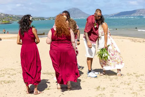 The bridesmaids dancing on the sand