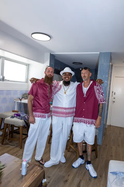 Erick with his groomsmen in wine red shirts