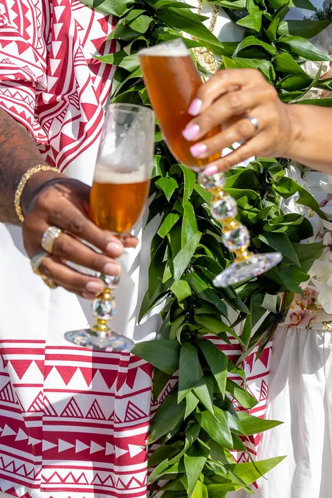 Close up of their glasses raised for the toast