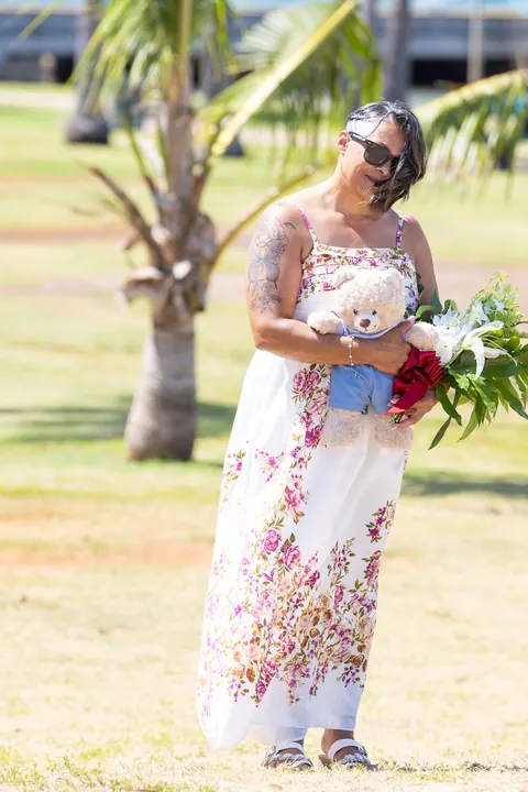 Jocelyn walking to the ceremony with her bouquet