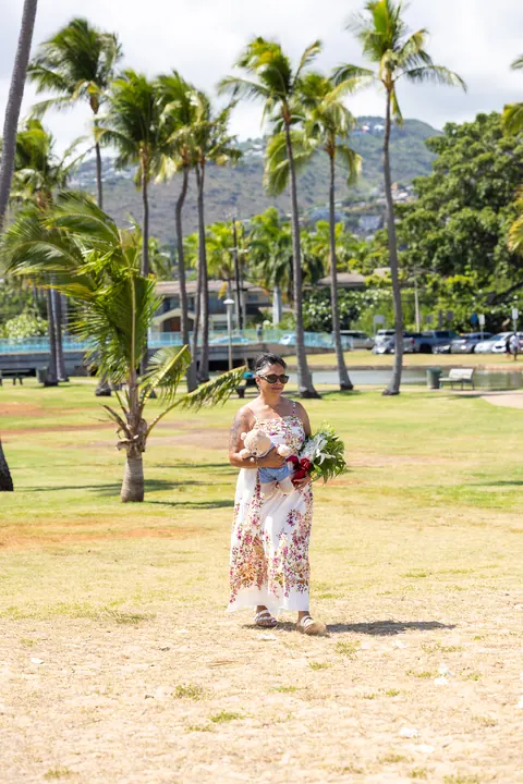 Jocelyn walking under the palm trees to the beach